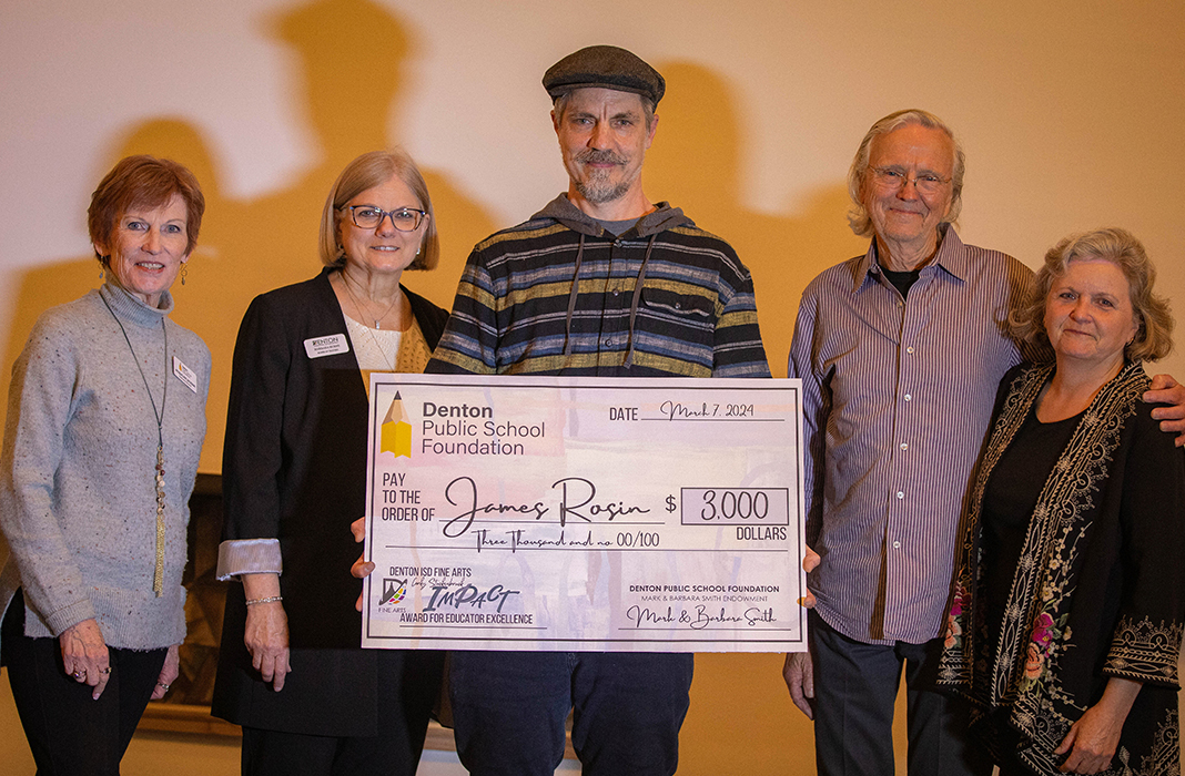 James Rosin, holding a check with people